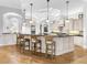Spacious kitchen with island seating, custom cabinetry, and coffered ceilings at 7921 Waterton Ln, Lakewood Ranch, FL 34202