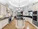 Gourmet kitchen with a central island, stainless steel appliances, and custom cabinetry at 7921 Waterton Ln, Lakewood Ranch, FL 34202