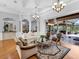 Spacious living room with elegant columns, seamless indoor/outdoor flow to the covered patio, and hardwood floors at 7921 Waterton Ln, Lakewood Ranch, FL 34202