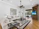 Bright living room features hardwood floors, neutral decor, and entertainment center at 7921 Waterton Ln, Lakewood Ranch, FL 34202