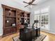 Office space with large wooden bookcase, desk, and a window for natural light at 7921 Waterton Ln, Lakewood Ranch, FL 34202