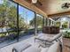 Screened patio with outdoor bar, lounge chairs and ceiling fans with serene lake views at 7921 Waterton Ln, Lakewood Ranch, FL 34202