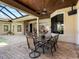 Expansive brick patio with dining and outdoor seating area with views into the house at 7921 Waterton Ln, Lakewood Ranch, FL 34202