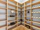 Well-organized walk-in pantry with light wood shelving, perfect for kitchen storage at 7921 Waterton Ln, Lakewood Ranch, FL 34202