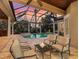 Relaxing patio with comfortable seating area overlooking a screened-in pool and lake at 7921 Waterton Ln, Lakewood Ranch, FL 34202