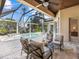 Relaxing screened-in patio area, with a swimming pool, comfortable seating, and lovely lake views at 7921 Waterton Ln, Lakewood Ranch, FL 34202