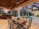 Spacious patio with a dining area, poolside seating, and a screened enclosure, perfect for outdoor entertainment at 7921 Waterton Ln, Lakewood Ranch, FL 34202