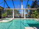 Inviting pool with a spa and lush tropical landscaping in a screened-in enclosure offering great views at 7921 Waterton Ln, Lakewood Ranch, FL 34202