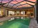 A large in-ground pool with access to multiple areas of the house and an outdoor kitchen at 7921 Waterton Ln, Lakewood Ranch, FL 34202