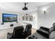 Home theater featuring a large screen, projector, and comfortable seating for an immersive viewing experience at 7921 Waterton Ln, Lakewood Ranch, FL 34202