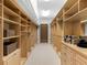 This walk-in closet features built-in shelves and drawers for maximum storage convenience at 7921 Waterton Ln, Lakewood Ranch, FL 34202