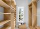 A stylish walk-in closet features custom-built shelving, great natural light, and ample storage at 7921 Waterton Ln, Lakewood Ranch, FL 34202