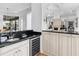 Wet bar with black countertops, white cabinets, and a wine fridge at 7921 Waterton Ln, Lakewood Ranch, FL 34202