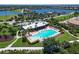 Resort-style community pool with abundant lounge seating and clubhouse by the lake at 1020 Tidewater Shores Loop # 107, Bradenton, FL 34208
