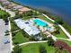 Aerial view showcasing the pool, clubhouse, and lush landscaping of the community at 1020 Tidewater Shores Loop # 107, Bradenton, FL 34208
