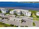 Aerial view of condo buildings with covered parking, manicured grounds, and stunning water views at 1020 Tidewater Shores Loop # 107, Bradenton, FL 34208