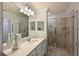 Bathroom with a large mirror, updated vanity, and a glass-enclosed shower at 1020 Tidewater Shores Loop # 107, Bradenton, FL 34208