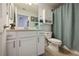 Bathroom with a white vanity, toilet, and shower featuring a shower curtain at 1020 Tidewater Shores Loop # 107, Bradenton, FL 34208