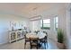 Bright dining area with water views, a round table, and a stylish light fixture at 1020 Tidewater Shores Loop # 107, Bradenton, FL 34208