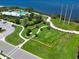 Aerial view of a well-maintained dog park, featuring lush green grass at 1020 Tidewater Shores Loop # 107, Bradenton, FL 34208