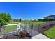 Fenced dog park with green grass, walking path, and waste station for pet owners' convenience at 1020 Tidewater Shores Loop # 107, Bradenton, FL 34208