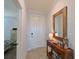 Inviting foyer with a decorative table and beach-themed decor, adjacent to the main bedroom at 1020 Tidewater Shores Loop # 107, Bradenton, FL 34208