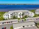 Drone shot of condo building with a waterfront view, assigned covered parking, and landscaped entrance at 1020 Tidewater Shores Loop # 107, Bradenton, FL 34208