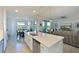 Open-concept kitchen with stainless steel appliances, an island, and views of the water at 1020 Tidewater Shores Loop # 107, Bradenton, FL 34208