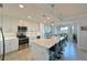 Modern kitchen featuring stainless steel appliances, a large island with seating, and bright, white cabinetry at 1020 Tidewater Shores Loop # 107, Bradenton, FL 34208