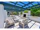 Outdoor grill area with a built-in grill, seating area, and pergola at 1020 Tidewater Shores Loop # 107, Bradenton, FL 34208