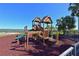 Community playground features slides, climbing areas, and a soft surface for safety at 1020 Tidewater Shores Loop # 107, Bradenton, FL 34208