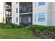 Exterior view of a screened lanai with outdoor furniture, offering a private and relaxing space at 1020 Tidewater Shores Loop # 107, Bradenton, FL 34208