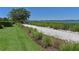 Scenic waterfront walking path, lined with manicured landscaping, provides a tranquil community amenity at 1020 Tidewater Shores Loop # 107, Bradenton, FL 34208