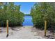 A picturesque view of waterfront access through lush greenery, offering a tranquil escape at 1020 Tidewater Shores Loop # 107, Bradenton, FL 34208