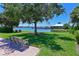 Scenic water views from a lakeside park bench, surrounded by lush greenery and serene waters at 1020 Tidewater Shores Loop # 107, Bradenton, FL 34208