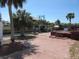 Tranquil waterfront backyard featuring a patio, lush palm trees, and a private boat dock for easy access to the water at 1027 Newton St, Englewood, FL 34224