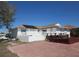 Expansive backyard featuring a patio, white railing, and access to waterfront views, creating a perfect outdoor living space at 1027 Newton St, Englewood, FL 34224