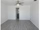 This bedroom has neutral paint, gray laminate flooring, and an ensuite bathroom, creating a comfortable and private retreat at 1027 Newton St, Englewood, FL 34224