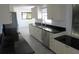 Bright kitchen features white cabinets, stainless steel appliances, and sleek black countertops at 1027 Newton St, Englewood, FL 34224