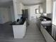 Bright and airy kitchen featuring stainless steel appliances, white cabinets, and sleek countertops at 1027 Newton St, Englewood, FL 34224