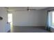 Bright living room with neutral walls, modern gray laminate flooring, and a large window offering plenty of natural light at 1027 Newton St, Englewood, FL 34224
