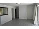 Spacious room featuring sleek flooring, neutral wall, light fixtures, and seamless access to the outdoors at 1027 Newton St, Englewood, FL 34224