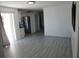 Open-concept living space with modern flooring leading into the kitchen and adjacent rooms at 1027 Newton St, Englewood, FL 34224