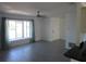 Bright and airy living room featuring sleek gray flooring, large window, and fresh, neutral paint creating an inviting space at 1027 Newton St, Englewood, FL 34224