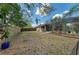 Lush backyard with a screened-in pool area, complemented by mature trees and partial fencing at 1127 133Rd E St, Bradenton, FL 34212