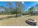 Picturesque backyard featuring a scenic pond, lush greenery, and a charming fire pit area at 1127 133Rd E St, Bradenton, FL 34212