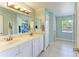 Bright bathroom featuring a double vanity, tiled floors, and a shower with a stylish curtain at 1127 133Rd E St, Bradenton, FL 34212