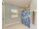 Bathroom featuring a shower with leafy patterned shower curtain and a window for natural light at 1127 133Rd E St, Bradenton, FL 34212