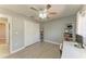 Bedroom with light gray walls and wood-look floors, complemented by white trim and a ceiling fan at 1127 133Rd E St, Bradenton, FL 34212