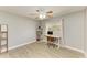 Bedroom featuring neutral walls, wood-look flooring, a ceiling fan, and a charming desk with window view at 1127 133Rd E St, Bradenton, FL 34212